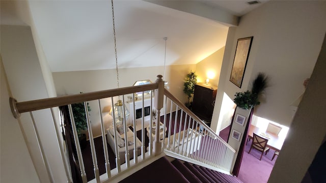 stairway with vaulted ceiling