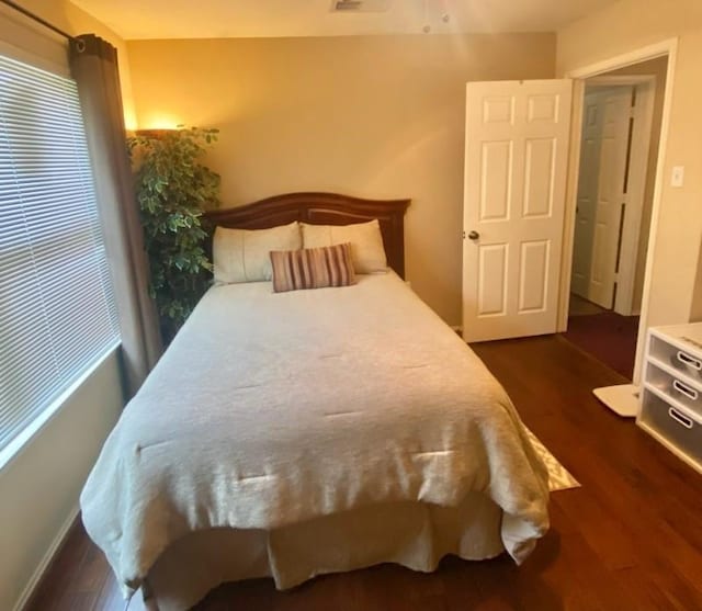 bedroom featuring dark wood-style flooring