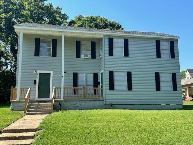 view of front of home with covered porch and a front yard