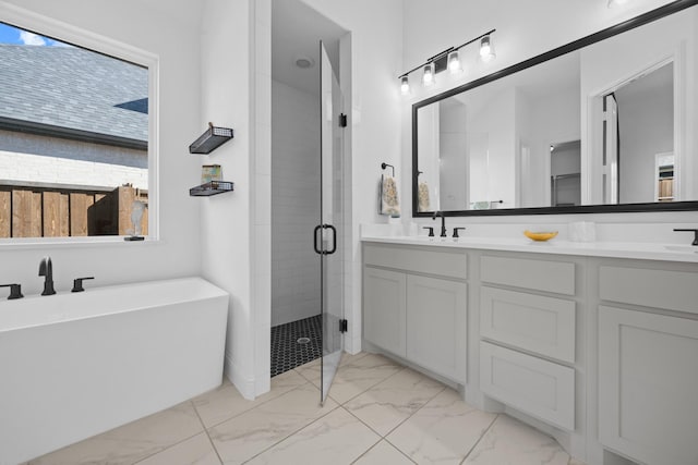 full bathroom with a sink, marble finish floor, a soaking tub, a shower stall, and double vanity