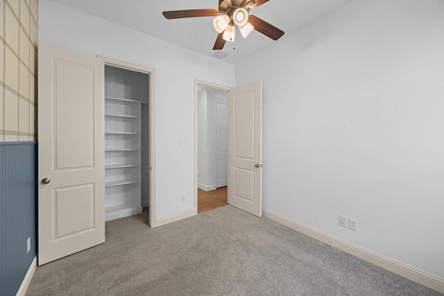 unfurnished bedroom with ceiling fan, baseboards, and light colored carpet