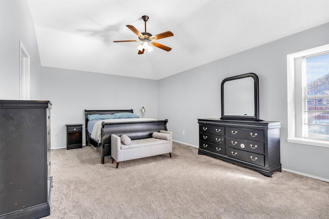 bedroom featuring carpet, ceiling fan, lofted ceiling, and baseboards