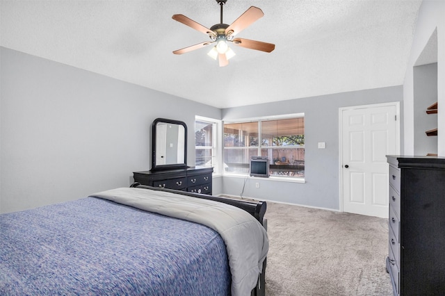 bedroom with carpet, lofted ceiling, ceiling fan, a textured ceiling, and baseboards