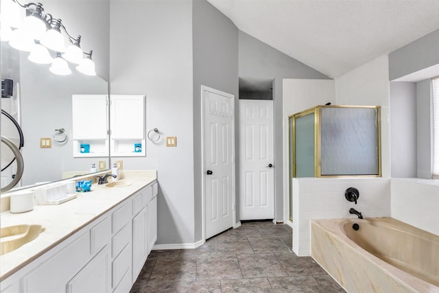 bathroom featuring double vanity, a stall shower, lofted ceiling, a bath, and a sink