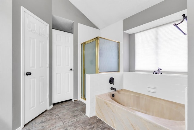 full bath featuring lofted ceiling, a stall shower, and a bath