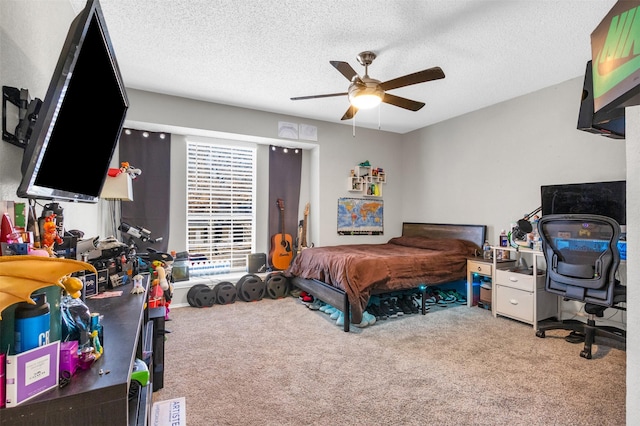 carpeted bedroom featuring ceiling fan and a textured ceiling