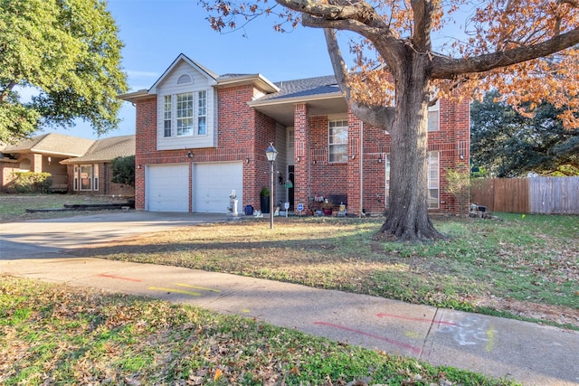 view of front of property featuring brick siding, fence, a garage, driveway, and a front lawn