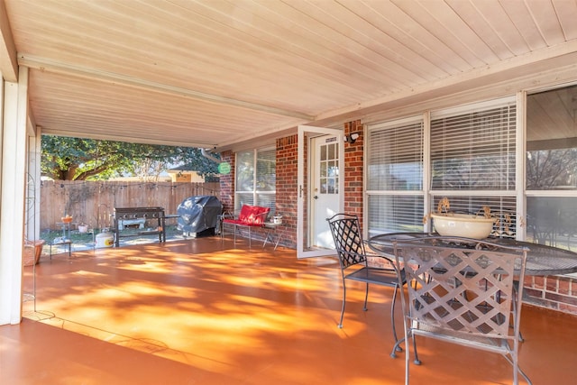 view of patio featuring covered porch, fence, and area for grilling