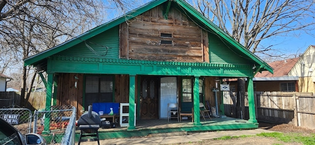 rear view of house with fence