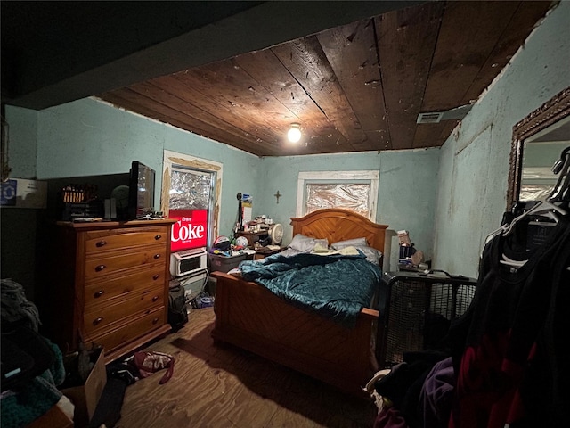 bedroom featuring wood ceiling, visible vents, and wood finished floors