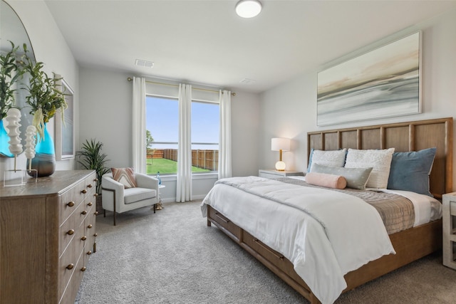 bedroom featuring light carpet and visible vents