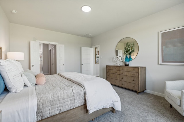 bedroom with carpet floors, visible vents, and baseboards