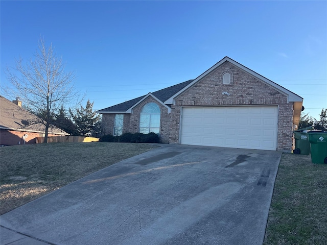 ranch-style house featuring driveway, a garage, a front lawn, and brick siding