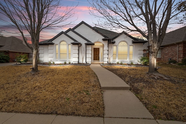 single story home featuring brick siding and roof with shingles