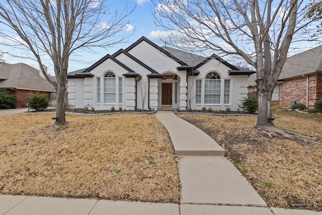 view of front of house with brick siding and a front lawn