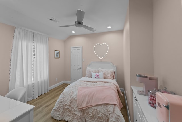 bedroom featuring light wood-style flooring, recessed lighting, visible vents, baseboards, and vaulted ceiling