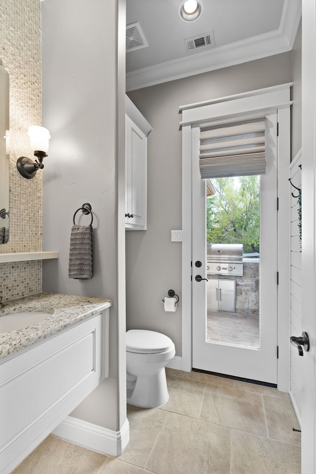 bathroom with visible vents, crown molding, vanity, and toilet