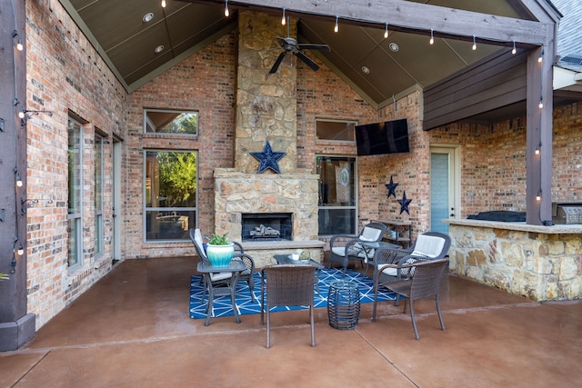 view of patio / terrace featuring an outdoor living space with a fireplace and ceiling fan