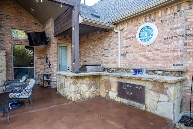 view of patio / terrace featuring exterior kitchen and outdoor wet bar