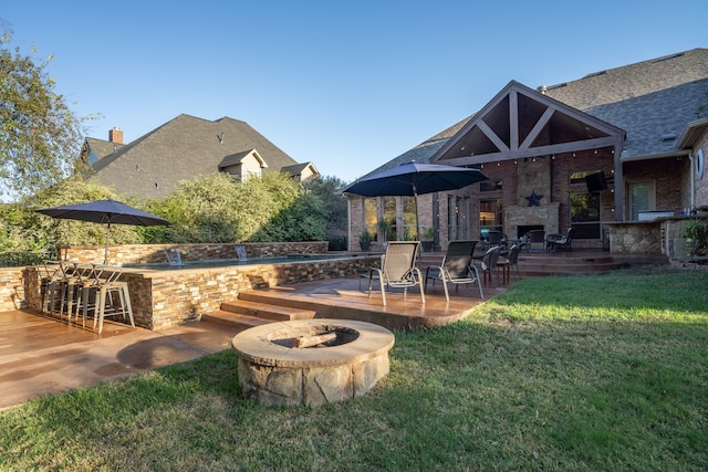 exterior space featuring an outdoor stone fireplace and outdoor dry bar