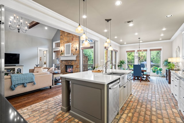 kitchen with decorative light fixtures, visible vents, open floor plan, a kitchen island with sink, and dishwasher