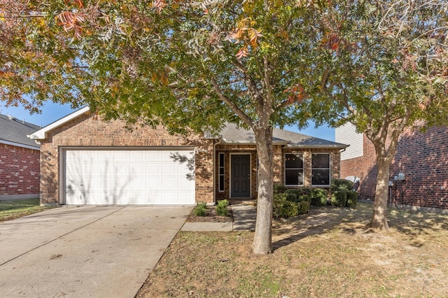 view of front of home featuring a garage, concrete driveway, and brick siding