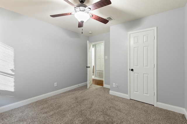 unfurnished bedroom featuring baseboards, visible vents, and carpet floors