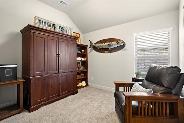 sitting room with light colored carpet, visible vents, lofted ceiling, and baseboards