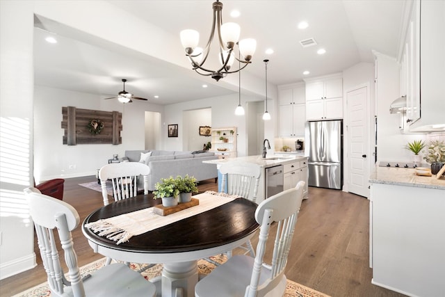 dining area featuring recessed lighting, ceiling fan with notable chandelier, dark wood-style flooring, visible vents, and baseboards