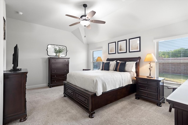 bedroom featuring lofted ceiling, multiple windows, baseboards, and light colored carpet