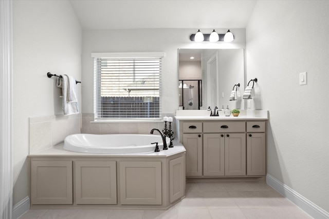 bathroom featuring tile patterned flooring, vanity, and a bath