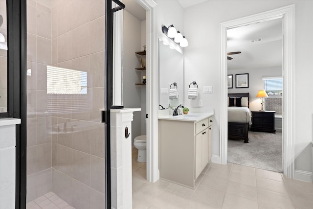 ensuite bathroom with visible vents, ensuite bathroom, a shower stall, vanity, and tile patterned floors