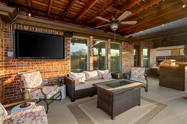 view of patio featuring exterior kitchen, an outdoor hangout area, grilling area, and a ceiling fan