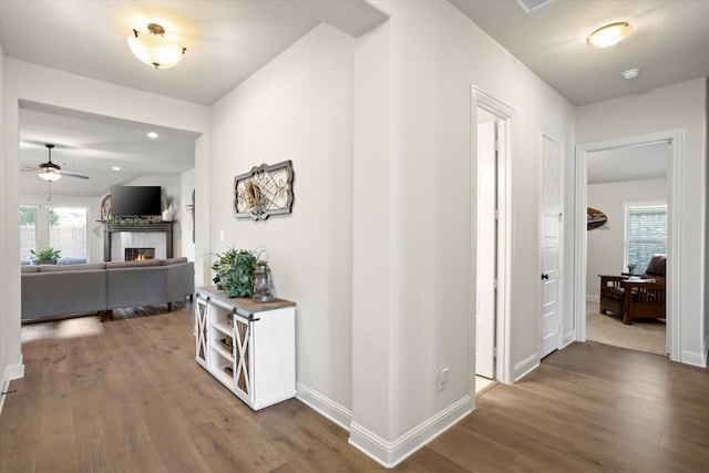 corridor with recessed lighting, baseboards, and wood finished floors