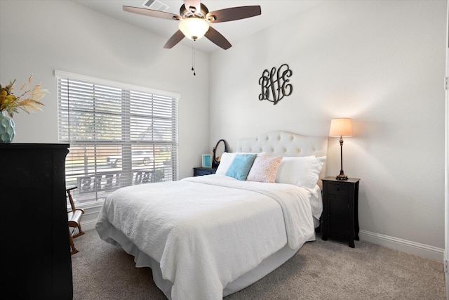 bedroom featuring light carpet, ceiling fan, and baseboards