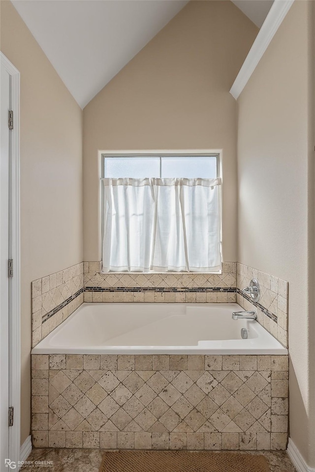 full bathroom with tiled bath and vaulted ceiling