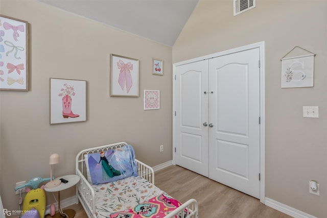 sitting room with lofted ceiling, baseboards, visible vents, and light wood-style floors