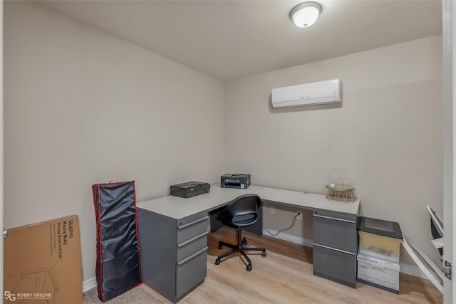 office space featuring baseboards, a wall mounted AC, and light wood-style floors