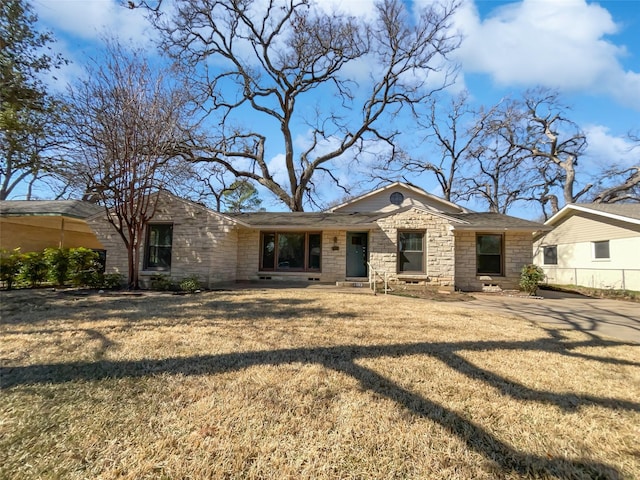 view of front of house featuring a front yard and stone siding