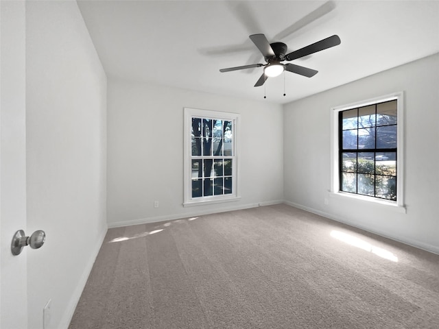 empty room featuring carpet, ceiling fan, and baseboards