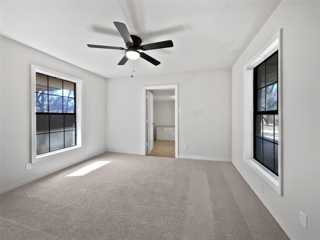 empty room with light carpet, ceiling fan, and baseboards