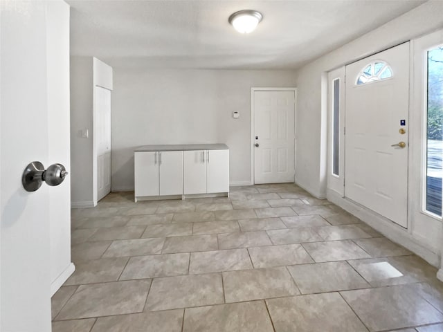 foyer featuring baseboards