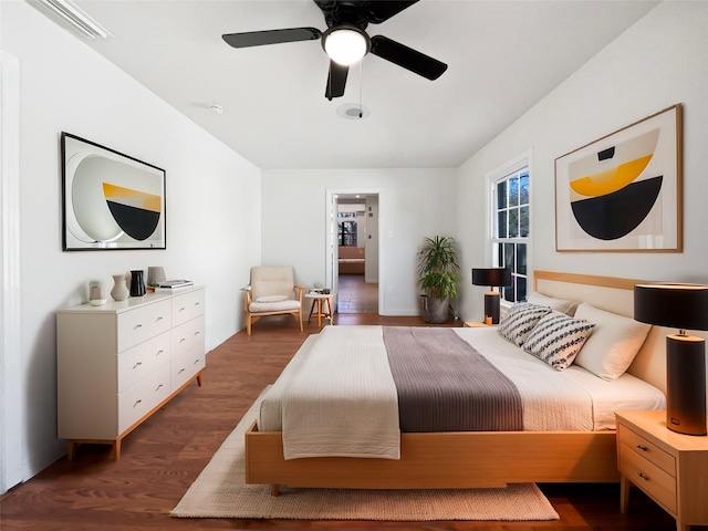 bedroom with dark wood finished floors, visible vents, and a ceiling fan