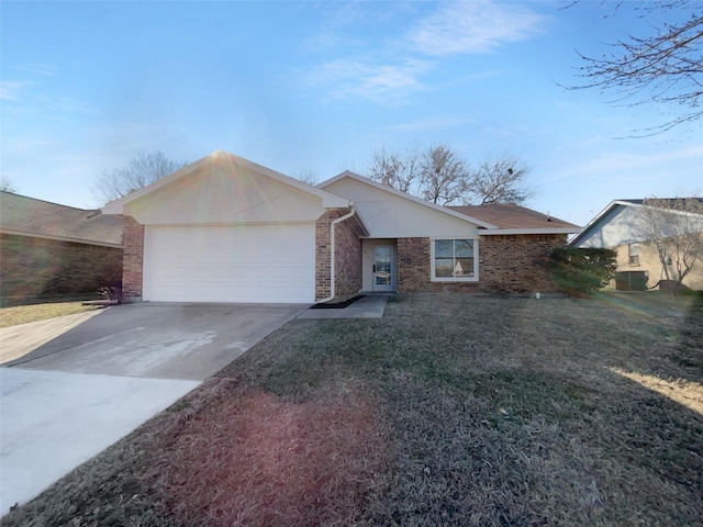 single story home with a front yard, concrete driveway, brick siding, and an attached garage