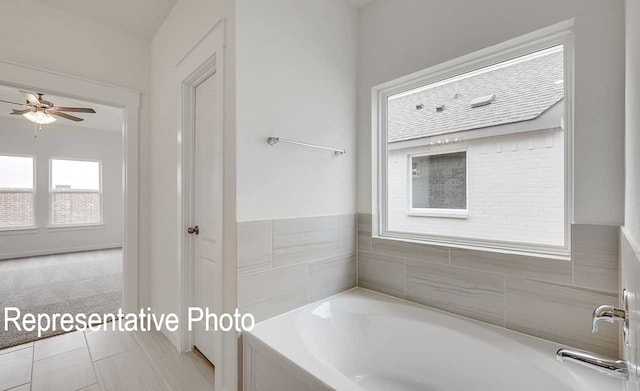 bathroom featuring ceiling fan and a garden tub