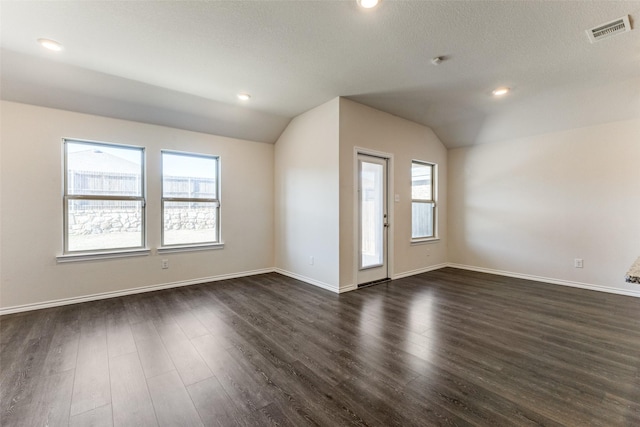 1023 Bedias Rd, Forney, TX 75126 - interior space with baseboards, visible vents, lofted ceiling, dark wood-type flooring, and a textured ceiling