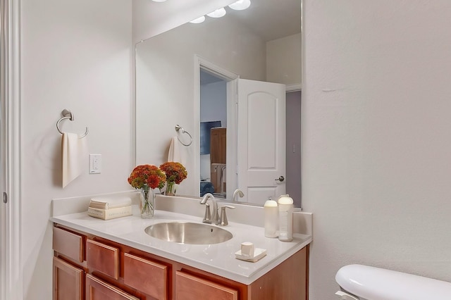 bathroom featuring toilet and vanity