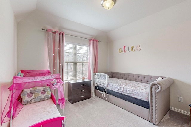 bedroom featuring light carpet and lofted ceiling