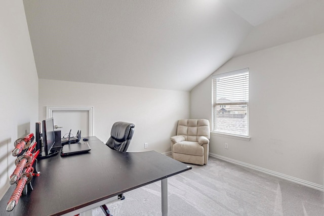 office space with baseboards, vaulted ceiling, and carpet flooring