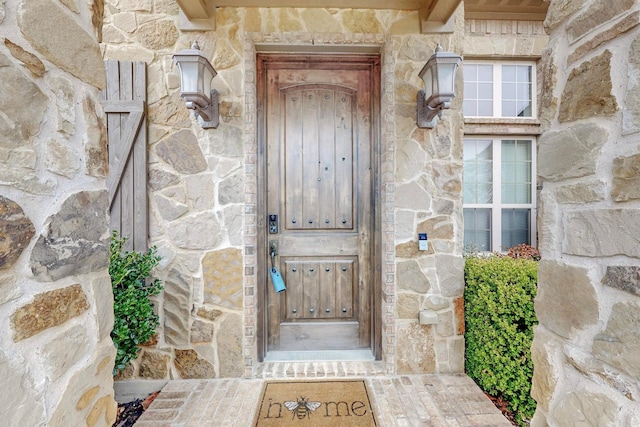 property entrance with stone siding